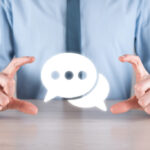 Businessman holding a message icon, bubble talk notification sign in his hands