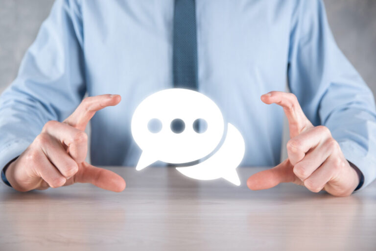 Businessman holding a message icon, bubble talk notification sign in his hands