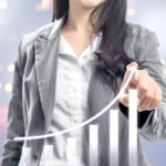 Business woman with fingers drawing growing 3D bar graph on virt