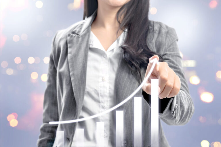 Business woman with fingers drawing growing 3D bar graph on virt