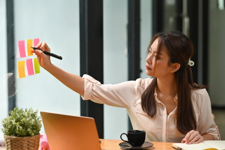 young-woman-using-phone-while-sitting-table